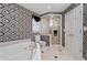 Luxurious bathroom featuring a shower, soaking tub, and designer wallpaper at 1405 Murdock Rd, Marietta, GA 30062
