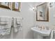 Half bathroom features pedestal sink, gold hardware, decorative towels, and framed mirror at 1405 Murdock Rd, Marietta, GA 30062
