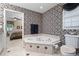 Relaxing bathroom offering a corner soaking tub, toilet, and stylish wallpaper at 1405 Murdock Rd, Marietta, GA 30062