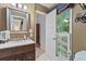 Bathroom features neutral colors, view of a window with blinds, and wood cabinet at 1405 Murdock Rd, Marietta, GA 30062