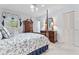 Bedroom features four poster bed, window with blinds, ceiling fan, and wood furnishings at 1405 Murdock Rd, Marietta, GA 30062