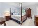 Bedroom with four poster bed, floral bedding, ceiling fan, and traditional furnishings at 1405 Murdock Rd, Marietta, GA 30062