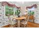 Bright eat-in kitchen with hardwood floors, decorative wallpaper and large windows at 1405 Murdock Rd, Marietta, GA 30062