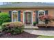 Inviting front entrance with a decorative door, beautiful plants, and accent lighting at 1405 Murdock Rd, Marietta, GA 30062