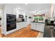 Well-lit kitchen featuring granite countertops, white cabinets, and stainless steel appliances at 1405 Murdock Rd, Marietta, GA 30062