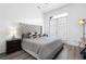 Bedroom with wood floors, tufted headboard, and natural light at 160 Fowler St # 100, Woodstock, GA 30188