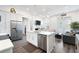 Bright open-concept kitchen with stainless steel appliances and adjacent living area at 160 Fowler St # 100, Woodstock, GA 30188