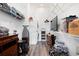 Well-organized laundry room with custom wood cabinets, overhead shelving, and a wall-mounted television at 160 Fowler St # 100, Woodstock, GA 30188