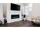 Living room featuring wood floors and a modern fireplace with accent lighting at 160 Fowler St # 100, Woodstock, GA 30188