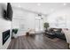 Bright living room featuring wood floors, a fireplace, and a modern design at 160 Fowler St # 100, Woodstock, GA 30188