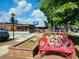 Charming street view with unique bench and views of Reel restaurant on a sunny day at 160 Fowler St # 100, Woodstock, GA 30188