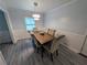 Bright dining room featuring hardwood floors, neutral paint, and contemporary light fixture at 1939 Suwanee Valley Rd, Lawrenceville, GA 30043