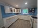 Bright kitchen featuring white cabinets, white counter tops, and a stylish tile backsplash at 1939 Suwanee Valley Rd, Lawrenceville, GA 30043