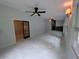 Open living room with white marble tile, ceiling fans, and access to the rest of the home at 1939 Suwanee Valley Rd, Lawrenceville, GA 30043