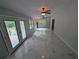 Bright sunroom featuring white marble tile, ceiling fans, and an exterior door at 1939 Suwanee Valley Rd, Lawrenceville, GA 30043