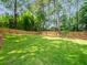 Lush, green backyard enclosed with a wooden fence and mature trees for added privacy at 2178 Tanglewood Rd, Decatur, GA 30033