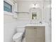 Bright bathroom featuring white tiles, a modern vanity, and a glass-enclosed shower at 2178 Tanglewood Rd, Decatur, GA 30033