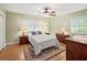 Cozy bedroom with hardwood floors, two windows offering natural light, and traditional-style furnishings at 2178 Tanglewood Rd, Decatur, GA 30033