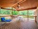 Inviting covered deck with wooden flooring and ceiling, stylish outdoor furniture, and views of the lush backyard at 2178 Tanglewood Rd, Decatur, GA 30033