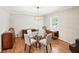 Charming dining room featuring hardwood floors, elegant lighting, and a stylish glass-top table at 2178 Tanglewood Rd, Decatur, GA 30033