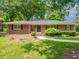 Charming single-story brick home with manicured lawn and inviting walkway, surrounded by mature trees at 2178 Tanglewood Rd, Decatur, GA 30033