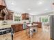 Well-appointed kitchen open to dining area featuring stainless appliances, granite counters, and center island at 2178 Tanglewood Rd, Decatur, GA 30033