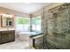 Bathroom featuring a soaking tub, glass shower, marble floors, and a vanity with a sink at 349 Harris Loop, Dallas, GA 30157