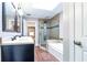 Bright bathroom featuring a double sink vanity, shower, tub, and wood-look tile floors at 349 Harris Loop, Dallas, GA 30157