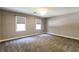 Bedroom featuring neutral carpet, neutral walls, ceiling fan, and large windows at 349 Harris Loop, Dallas, GA 30157