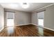 Neutral bedroom with hardwood floors, crown molding, neutral walls, and large windows at 349 Harris Loop, Dallas, GA 30157