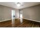 Bedroom with hardwood floors, neutral walls, crown molding, large windows, and a doorway to another room at 349 Harris Loop, Dallas, GA 30157