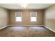 Neutral bedroom with carpeting and two windows providing natural light at 349 Harris Loop, Dallas, GA 30157