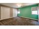 Bedroom with neutral carpet, mint walls, ceiling fan, and two large closets at 349 Harris Loop, Dallas, GA 30157