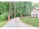 Long driveway leading up to the house, flanked by brick columns and a black metal fence at 349 Harris Loop, Dallas, GA 30157