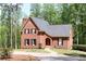 Charming brick home with black shutters, mature trees, and well-maintained landscaping at 349 Harris Loop, Dallas, GA 30157