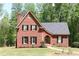 Charming red brick two-story home featuring black shutters, lush lawn, and beautiful landscaping at 349 Harris Loop, Dallas, GA 30157