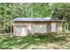 Three car detached garage, featuring two garage doors, a side door, and exterior lighting at 349 Harris Loop, Dallas, GA 30157