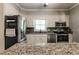 Kitchen with stainless steel appliances, granite countertops, and white cabinetry at 349 Harris Loop, Dallas, GA 30157