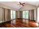 Bright living room featuring hardwood floors, neutral walls, vaulted ceilings, ceiling fan, and abundant natural light at 349 Harris Loop, Dallas, GA 30157