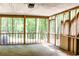 Enclosed screened porch providing views of a lush, wooded backyard at 349 Harris Loop, Dallas, GA 30157