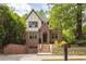 Charming brick two-story home featuring a gable roof, dormer windows, and a nicely landscaped front yard at 134 Woodlawn Ave, Decatur, GA 30030