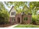 Charming brick two-story home featuring a gable roof, dormer windows, and a nicely landscaped front yard at 134 Woodlawn Ave, Decatur, GA 30030