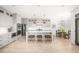 Spacious kitchen featuring white cabinets, an island with seating, stainless steel appliances, and hardwood floors at 134 Woodlawn Ave, Decatur, GA 30030