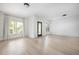 Living room features light hardwood flooring, two bright windows, and neutral paint at 134 Woodlawn Ave, Decatur, GA 30030