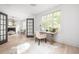 Bright office with large windows, hardwood floors, and stylish furniture adjacent to the living room at 134 Woodlawn Ave, Decatur, GA 30030