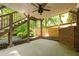 Inviting covered patio featuring ceiling fan, brick fireplace, and wood fence, ideal for outdoor relaxation and entertaining at 134 Woodlawn Ave, Decatur, GA 30030