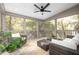 Screened porch featuring wicker furniture, ceiling fan, and wooded view at 134 Woodlawn Ave, Decatur, GA 30030