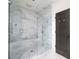 Luxurious walk-in shower featuring marble walls, glass enclosure, and stylish fixtures at 134 Woodlawn Ave, Decatur, GA 30030