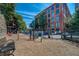 Fenced dog park offers residents space to exercise and play, with seating and shade at 170 Boulevard Se # E414, Atlanta, GA 30312