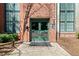 Building entrance with green doors, brick facade and concrete walkway at 170 Boulevard Se # E414, Atlanta, GA 30312
